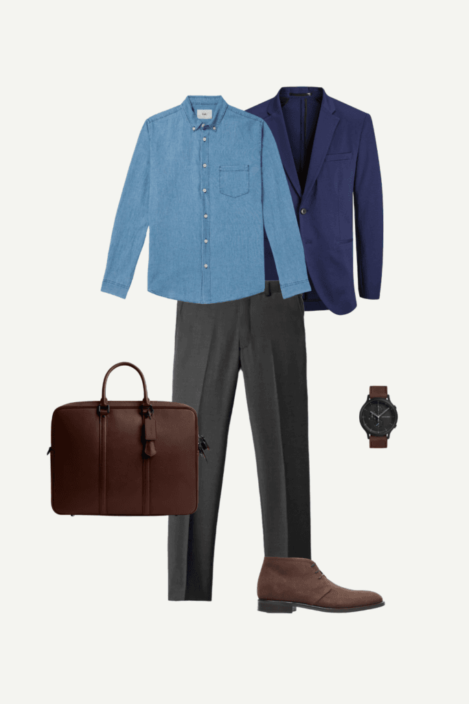 Business casual outfit for men with denim shirt, navy blazer, gray pants, and brown leather boots