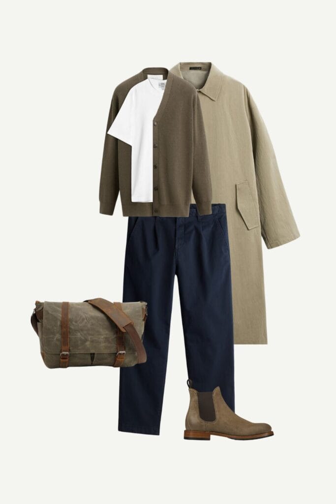Smart-casual spring outfit for men featuring a trench coat, white tee, olive cardigan, navy cropped chinos, suede Chelsea boots, and a canvas messenger bag.