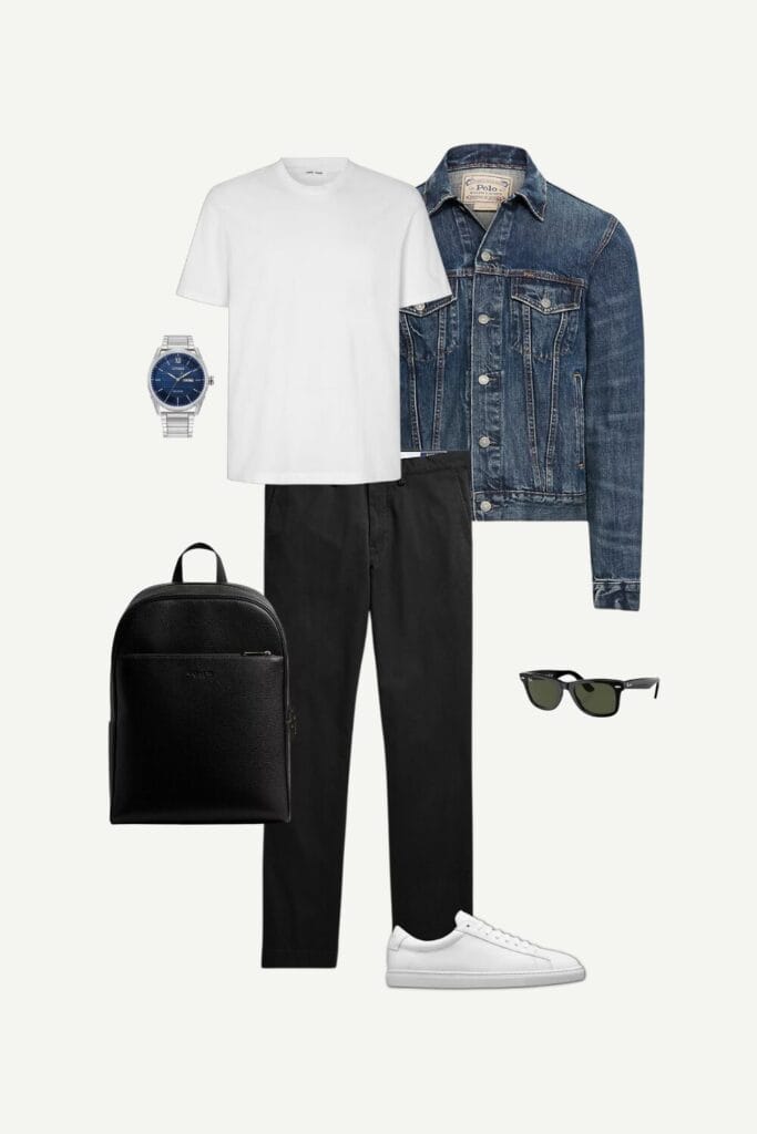 Flat lay of a men's smart casual spring outfit featuring a faded denim trucker jacket from Ralph Lauren, a white T-shirt by Samsoe Samsoe, black stretch chinos from Ralph Lauren, white minimalist sneakers by Oliver Cabell, a black leather backpack from Coach, a silver Citizen watch, and Ray-Ban Wayfarer sunglasses.