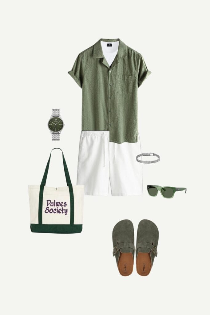 Flat lay of a casual summer outfit for men featuring an olive green button-up shirt, white linen-blend shorts, suede green clogs, a beige Palmes tote bag, Ray-Ban sunglasses, a white ribbed tank top, silver watch, and a stainless steel bracelet—perfect for relaxed summer days.