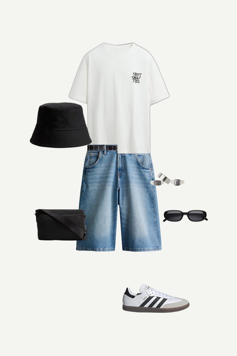 Flat lay of a casual summer streetwear outfit for men featuring a white graphic T-shirt, baggy light-wash denim shorts, black bucket hat, Adidas Samba sneakers, a nylon crossbody bag, silver rings, sunglasses, and a grommet belt—perfect for everyday laid-back style.
