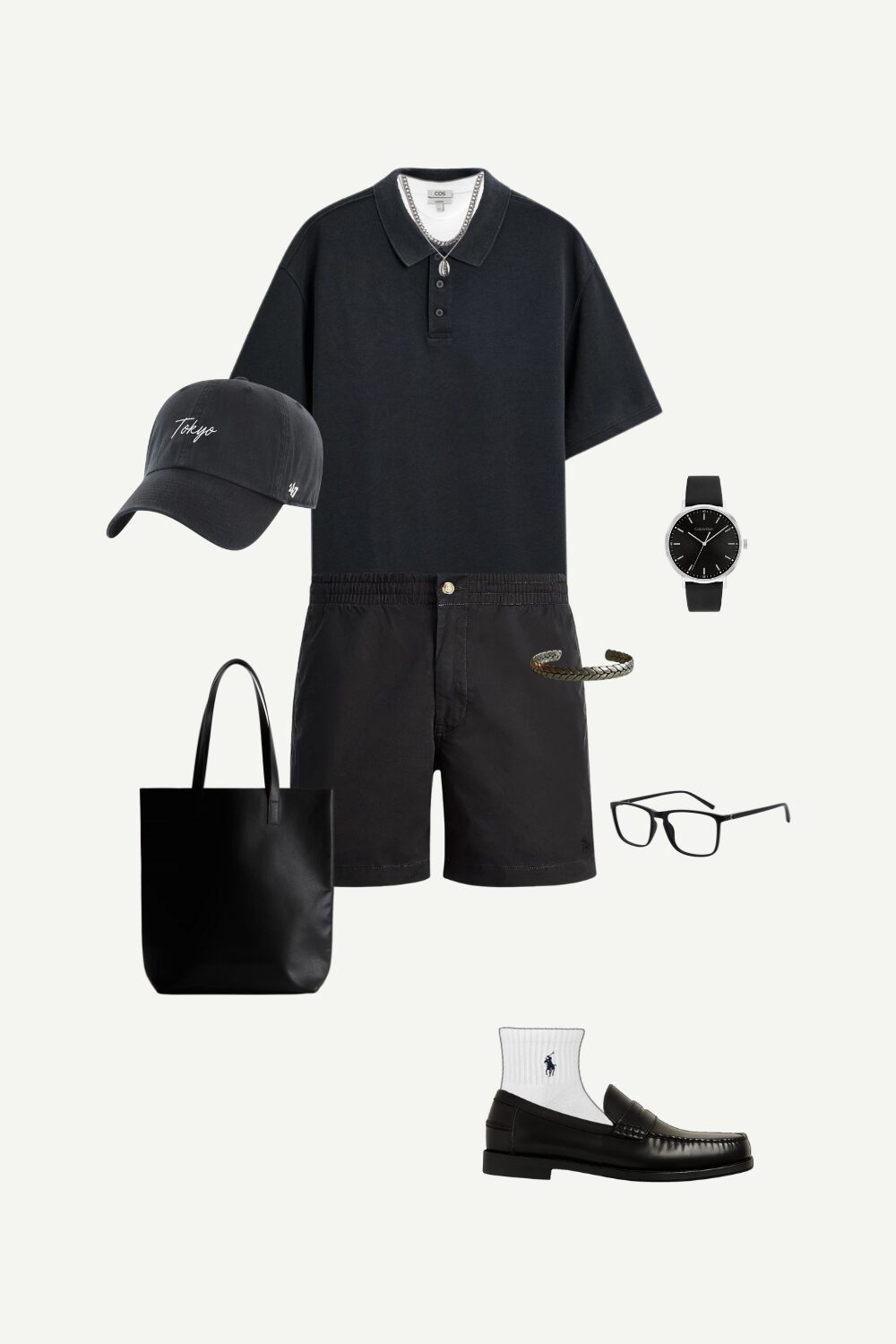 Flat lay of a casual summer streetwear outfit for men featuring a dark polo shirt, black linen shorts, loafers, and minimal accessories.