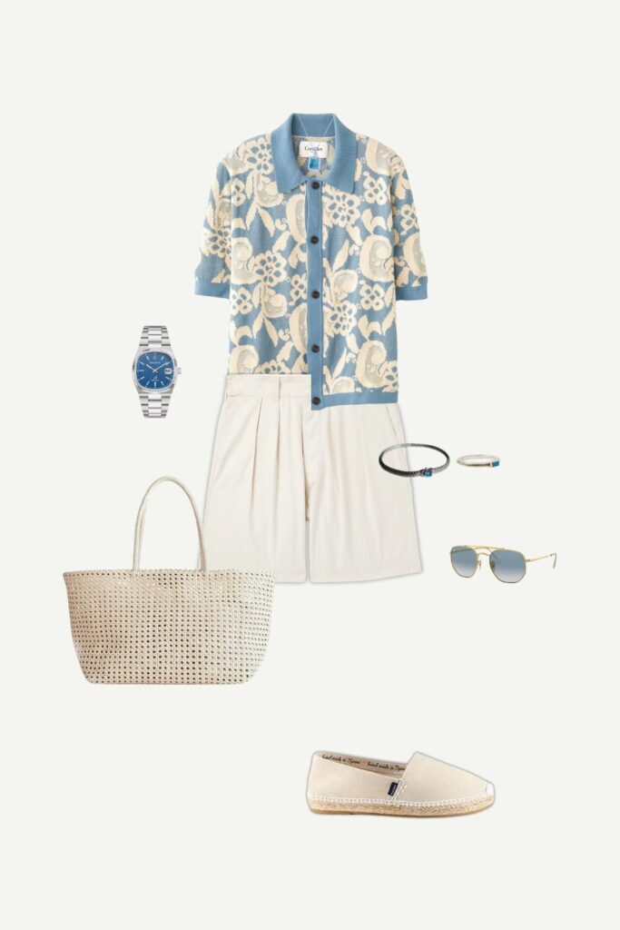Flat lay of a men’s summer smart casual outfit featuring a floral jacquard polo shirt, pleated shorts, canvas espadrilles, and silver jewelry.