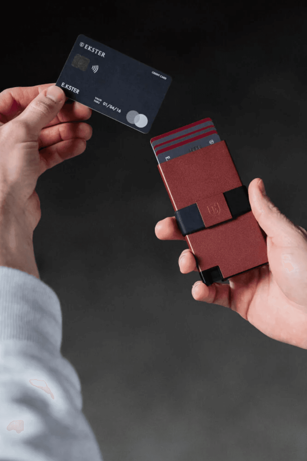 Red Ekster Pro Smart Cardholder Wallet in Hand